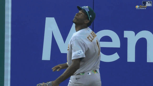 An animated gif of A's center fielder Denzel Clarke scaling the wall to rob a home run