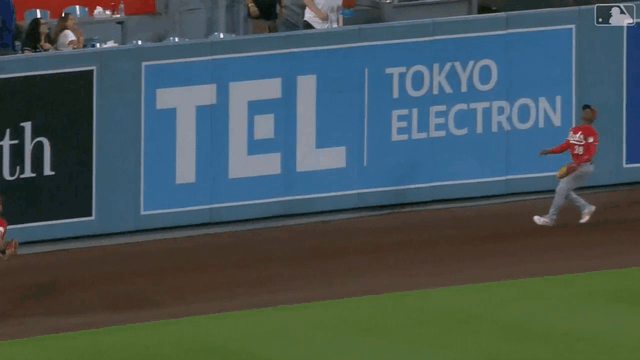 An animated gif of Reds outfielder Carlos Jorge making a leaping catch against the wall