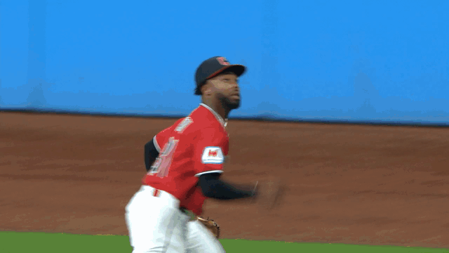 An animated gif of the Guardians' Kahlil Watson making a leaping catch against the wall in foul territory