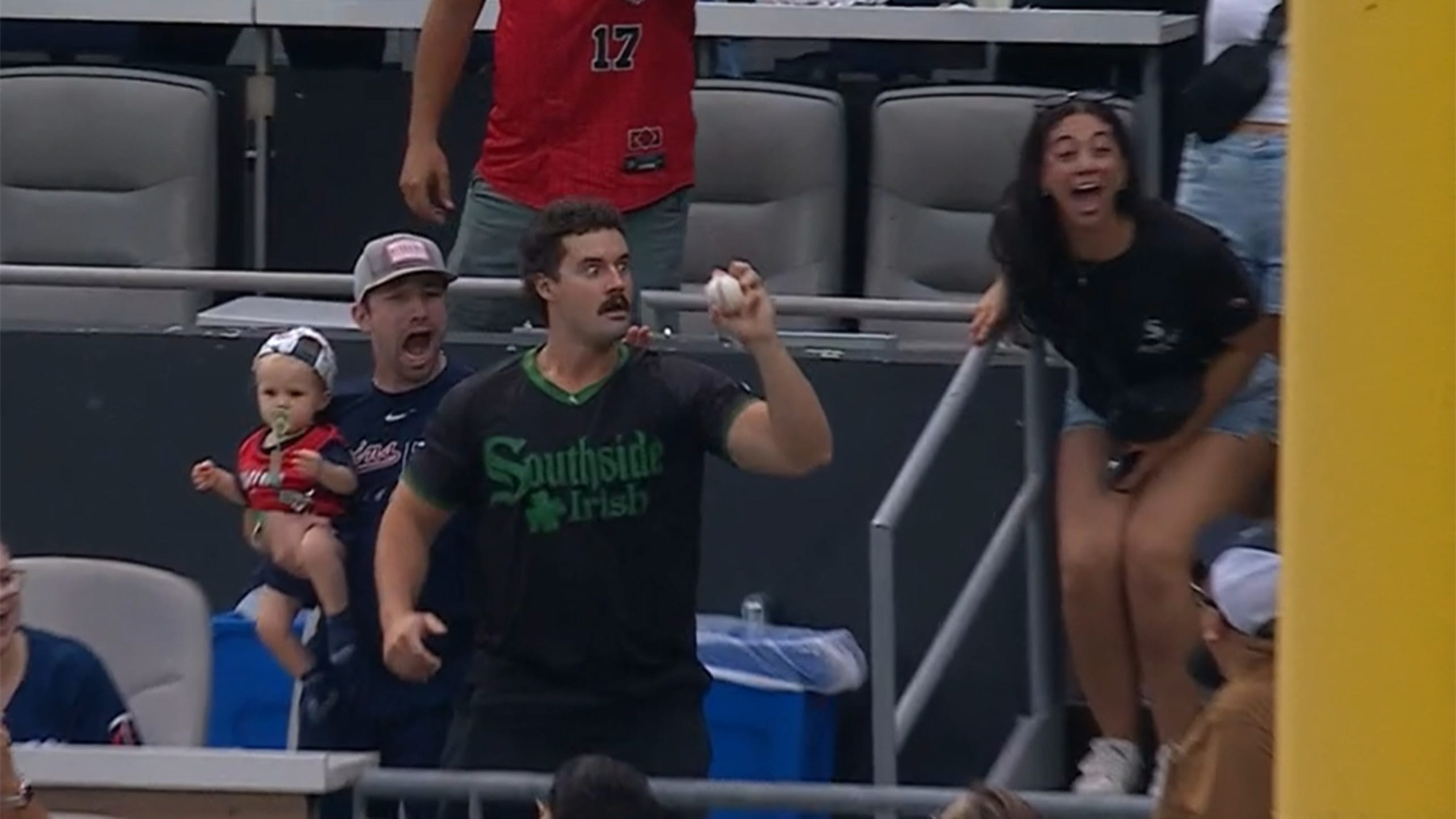A fan reacts with surprise after catching a home run ball