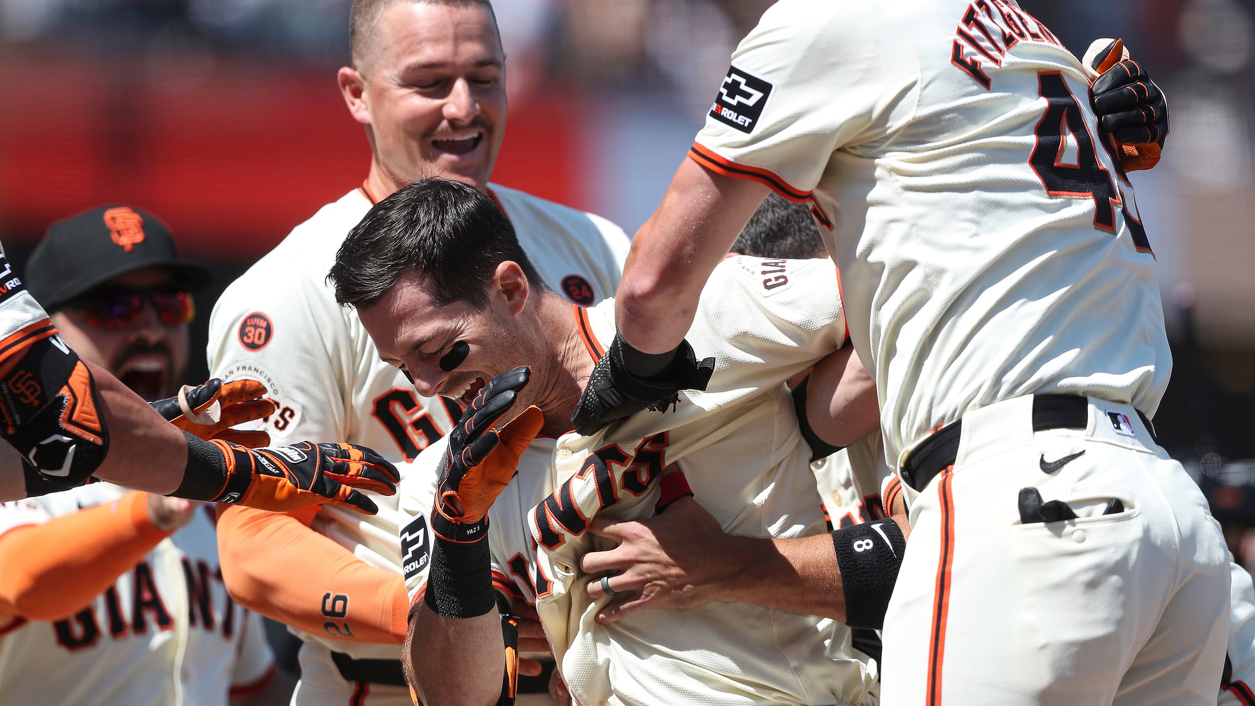 Mike Yastrzemski is mobbed after his walk-off hustle