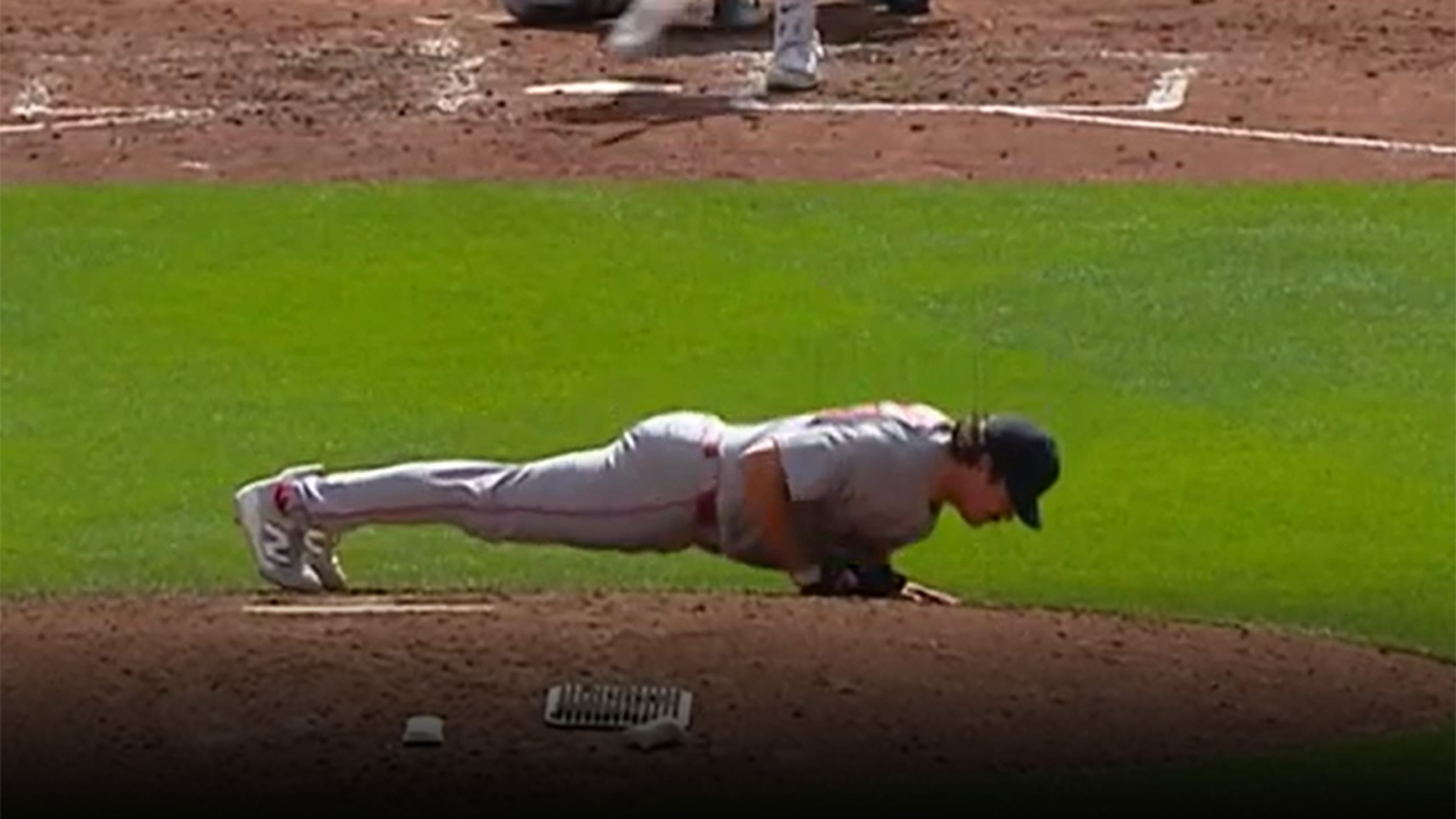 Payton Tolle does a push-up on pitcher's mound