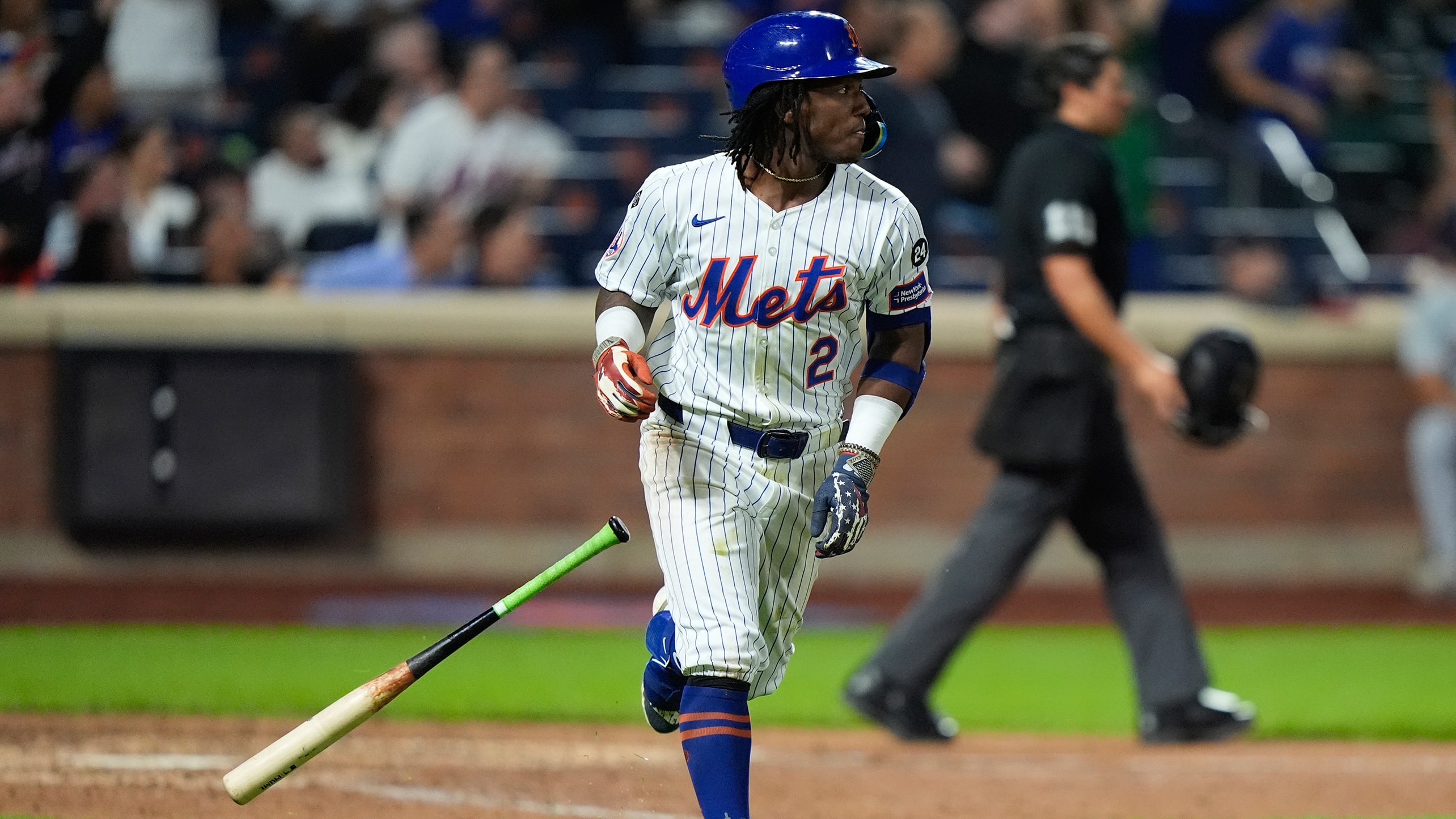 Luisangel Acuña flips his bat while watching the flight of his first career home run