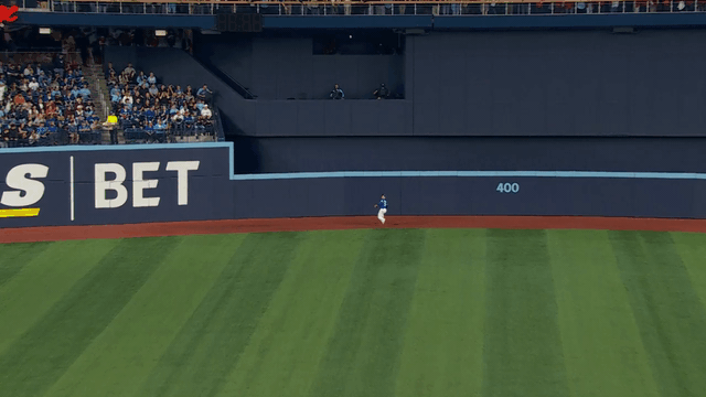 An animated gif of Daulton Varsho leaping into the wall to make a catch