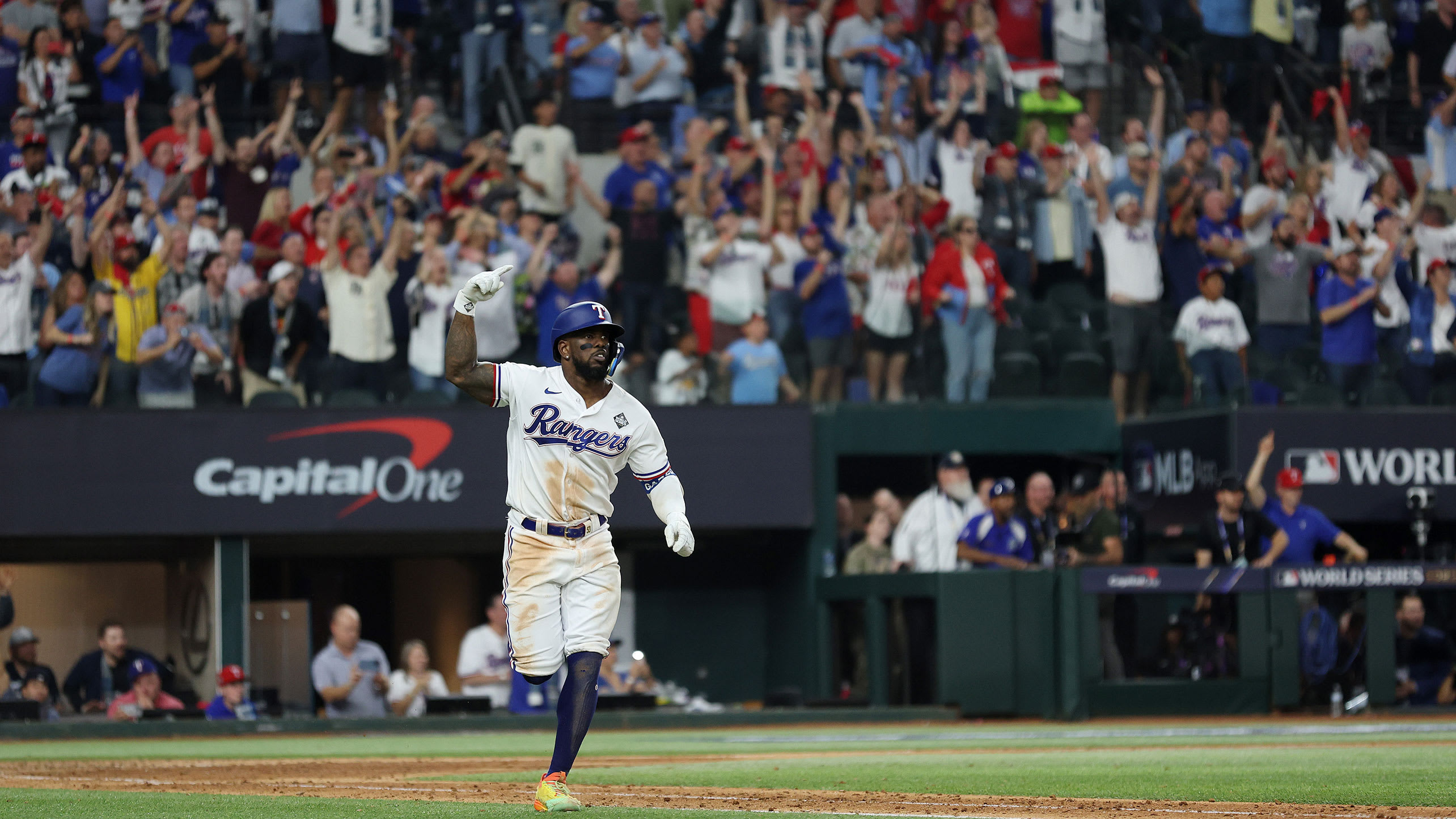 Adolis García runs down the line as fans cheer his walk-off home run