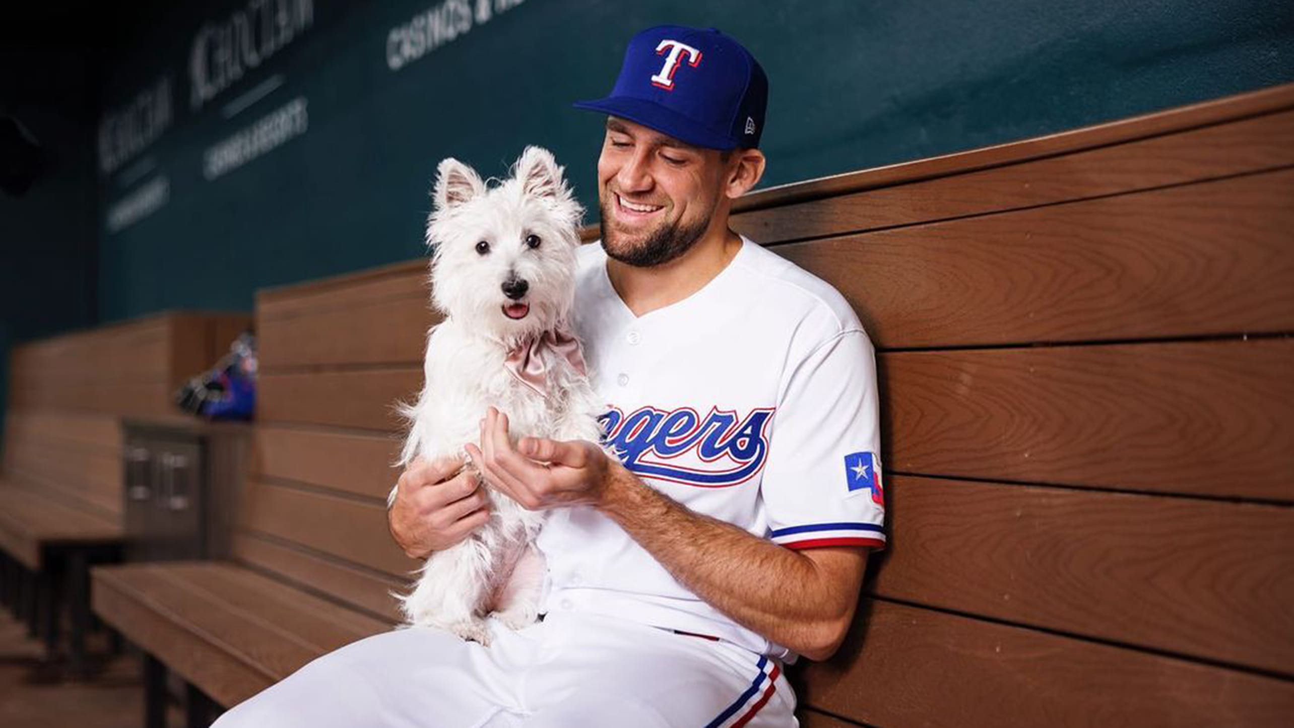Nathan Eovaldi holds his dog in the dugout