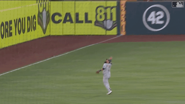 An animated gif of Astros third baseman Luis Guillorme making a leaping, lunging, over-the-shoulder catch before tumbling to the ground