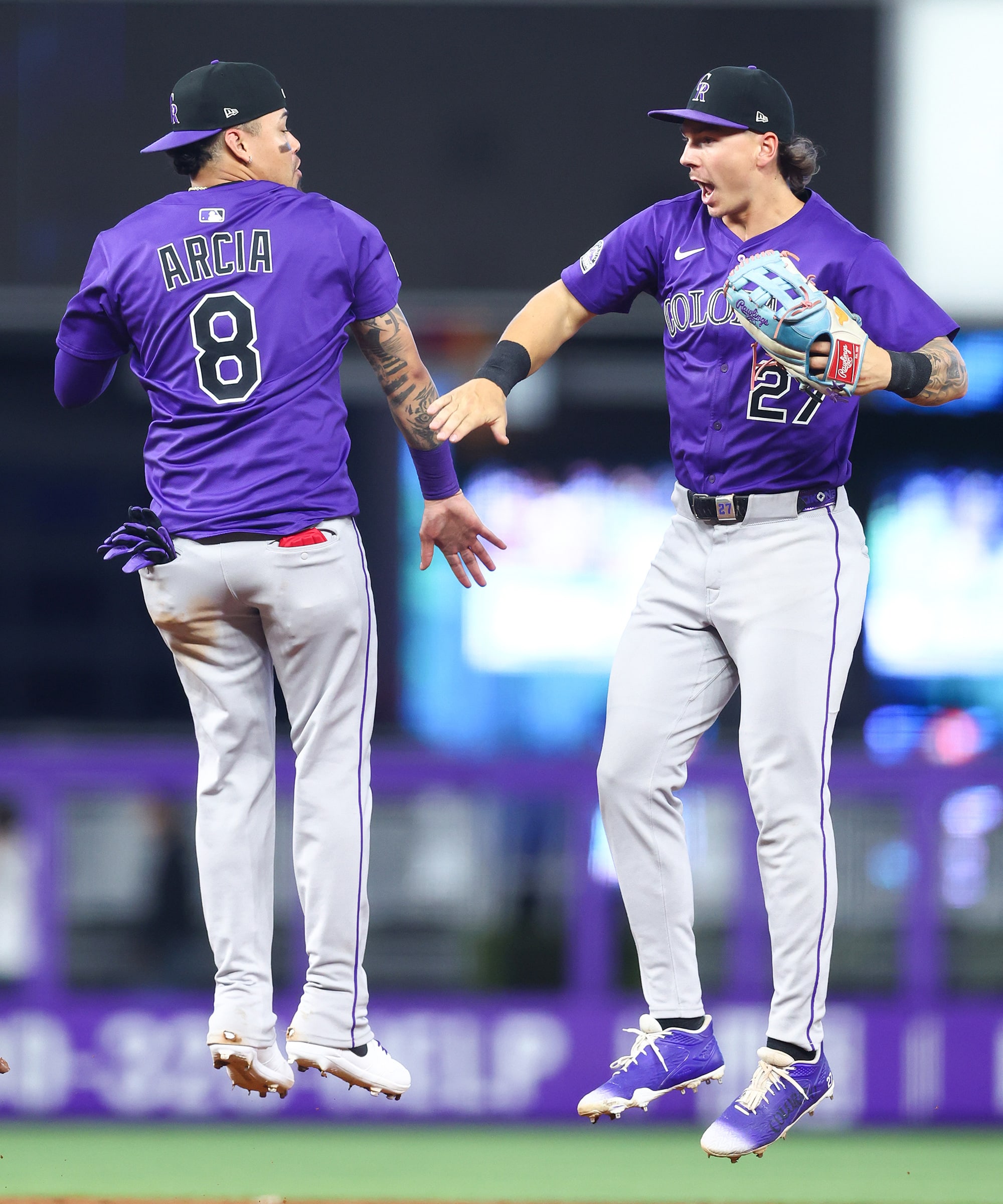 Orlando Arcia and Jordan Beck celebrate the Rockies' sweep of the Marlins