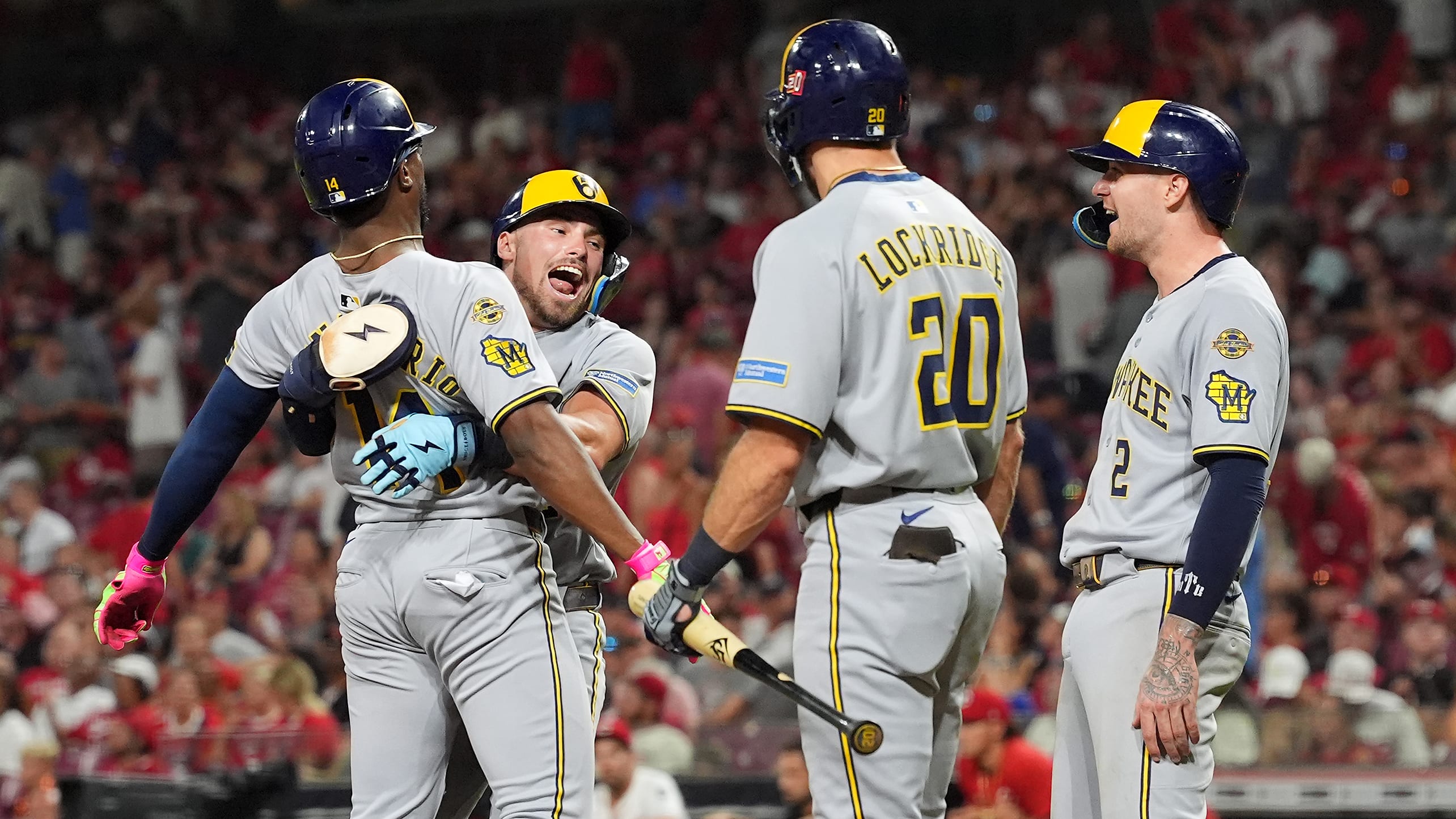 Andruw Monasterio is hugged by Caleb Durbin at home plate after hitting a go-ahead home run