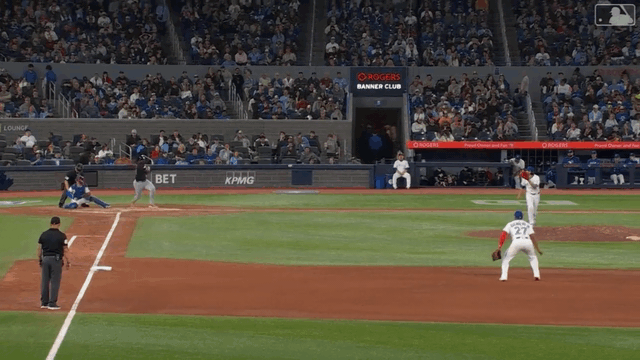 An animated gif of Vladimir Guerrero Jr. making a diving stop and throw