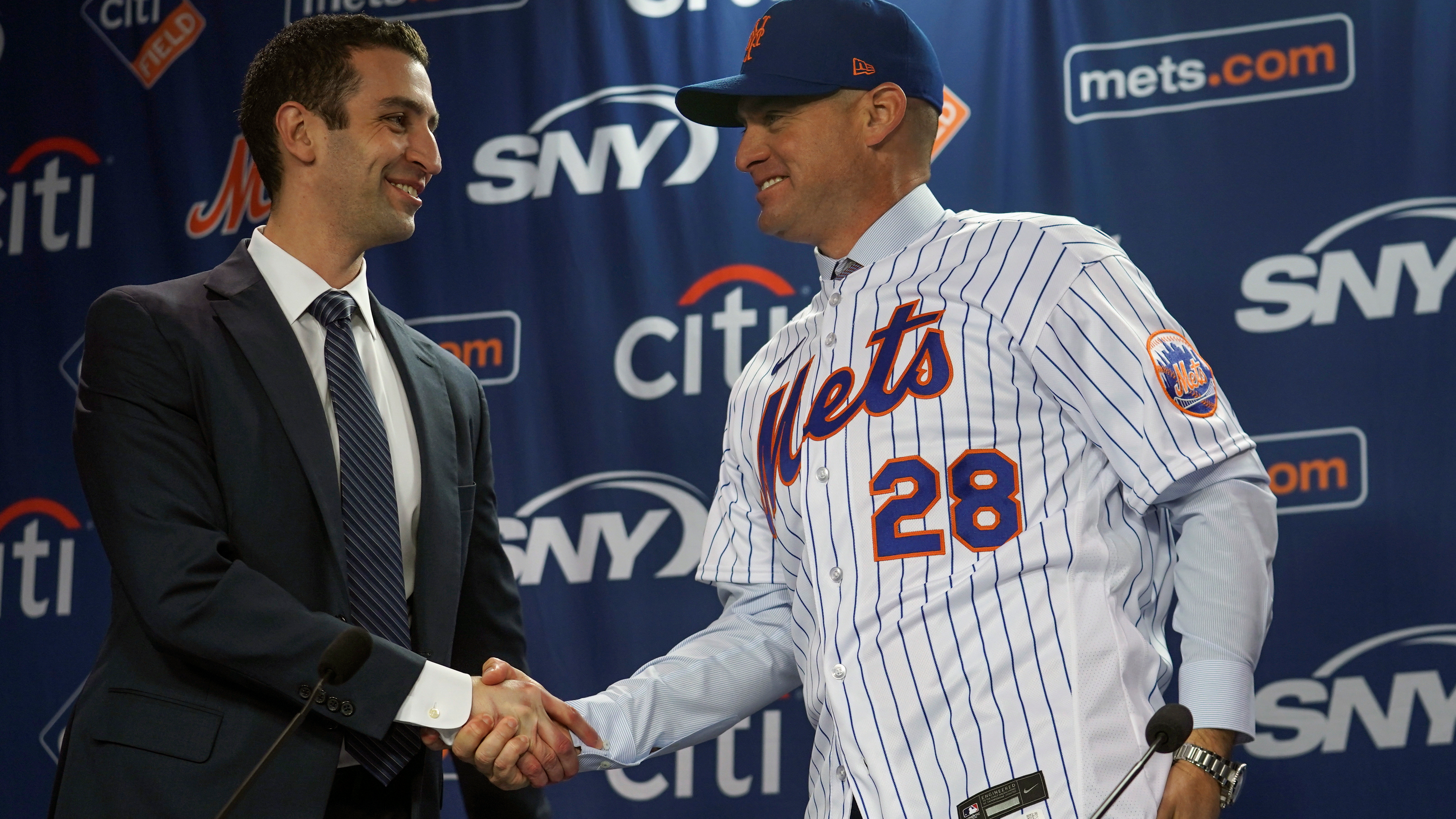 Mets president of baseball operations David Stearns shakes hands with new manager Carlos Mendoza
