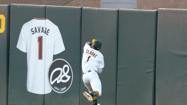 An animated gif of A's center fielder Denzel Clarke making a running catch and crashing hard into the outfield wall