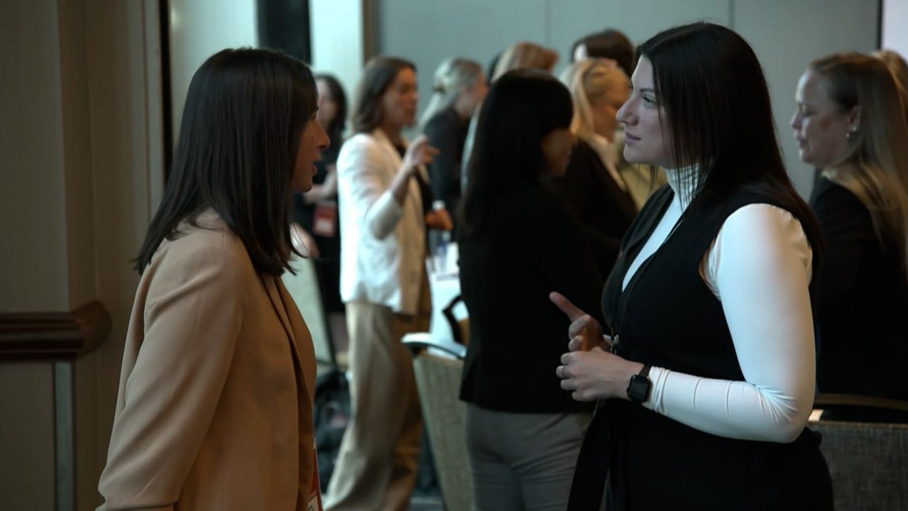 Two attendees chat at the Katy Feeney Leadership Luncheon