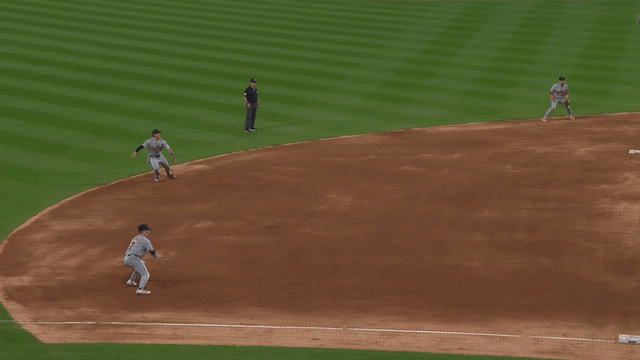 An animated GIF of Kevin McGonigle making a diving stop and throw to first