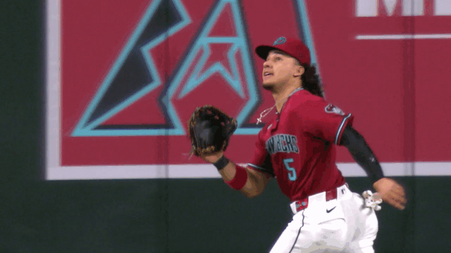 An animated gif of Alek Thomas making a sliding catch on the warning track