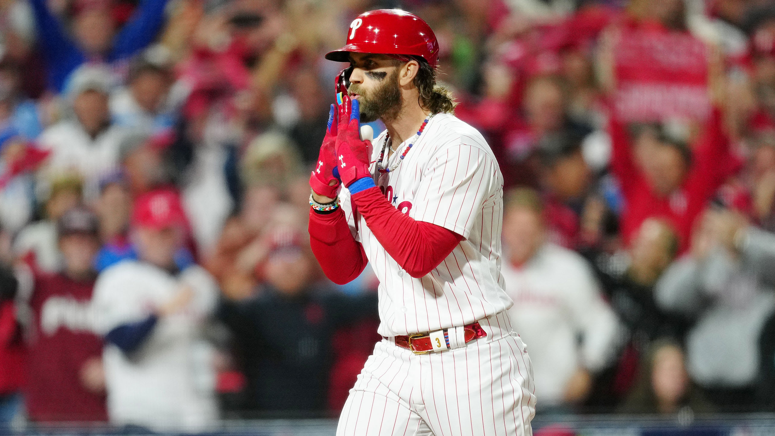 Bryce Harper celebrates his home run by blowing on his fingers as if they're birthday candles