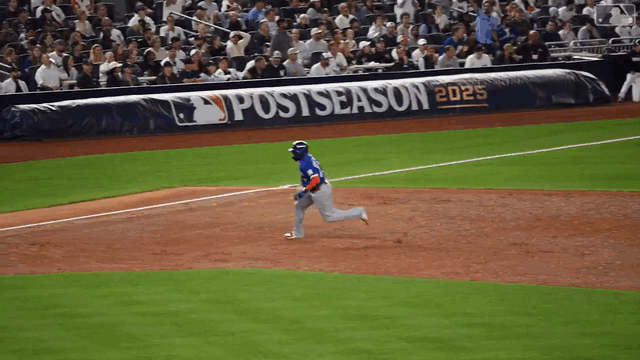 An animated gif of Vladimir Guerrero Jr. rounding third base and diving into home