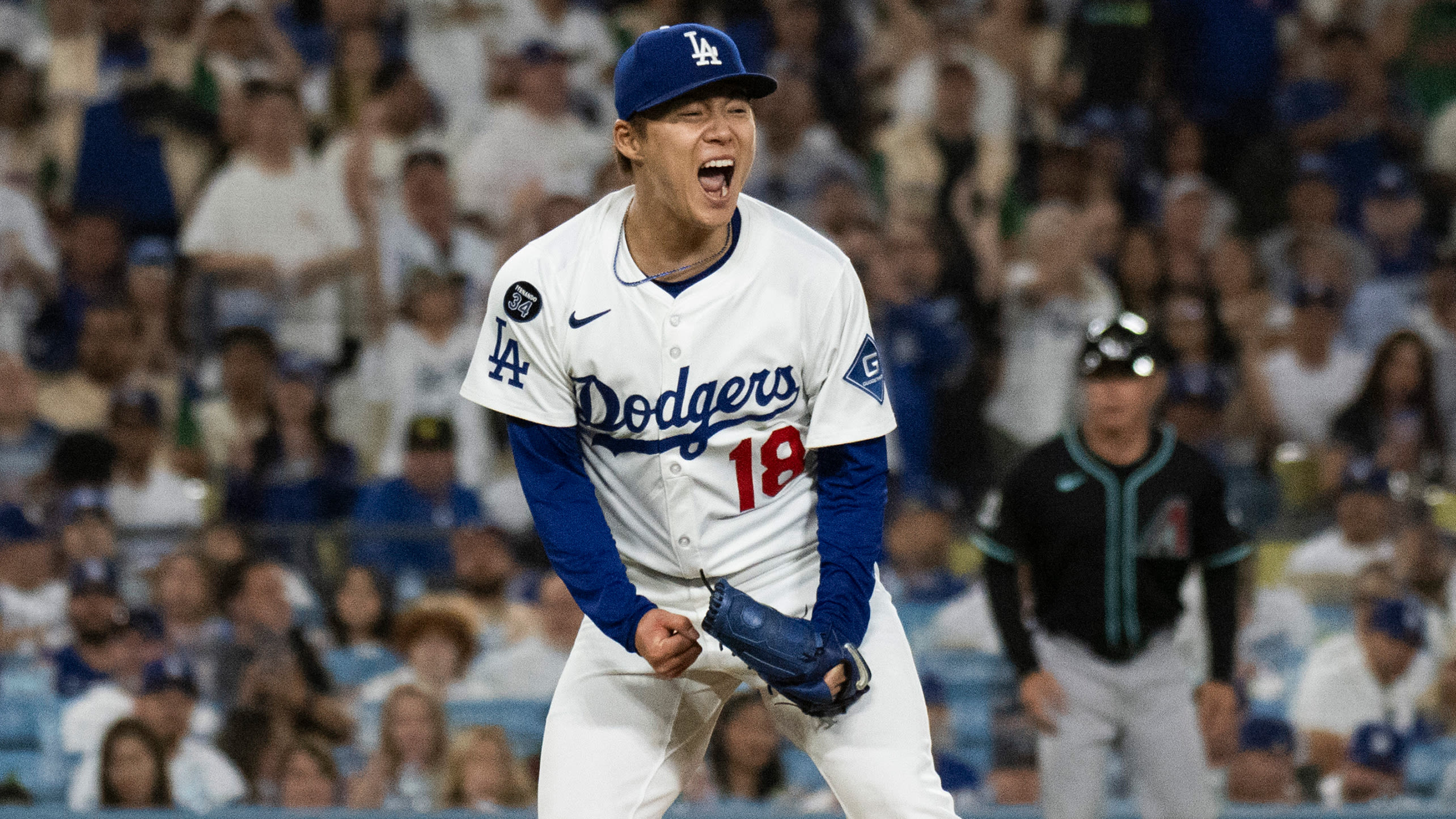 Yoshinobu Yamamoto lets out a yell after a big strikeout