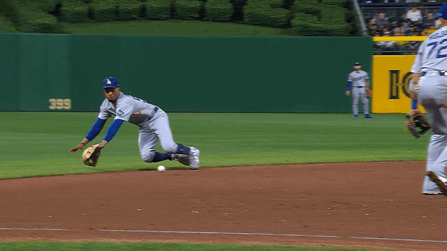 An animated gif of Mookie Betts making a diving stop and throw