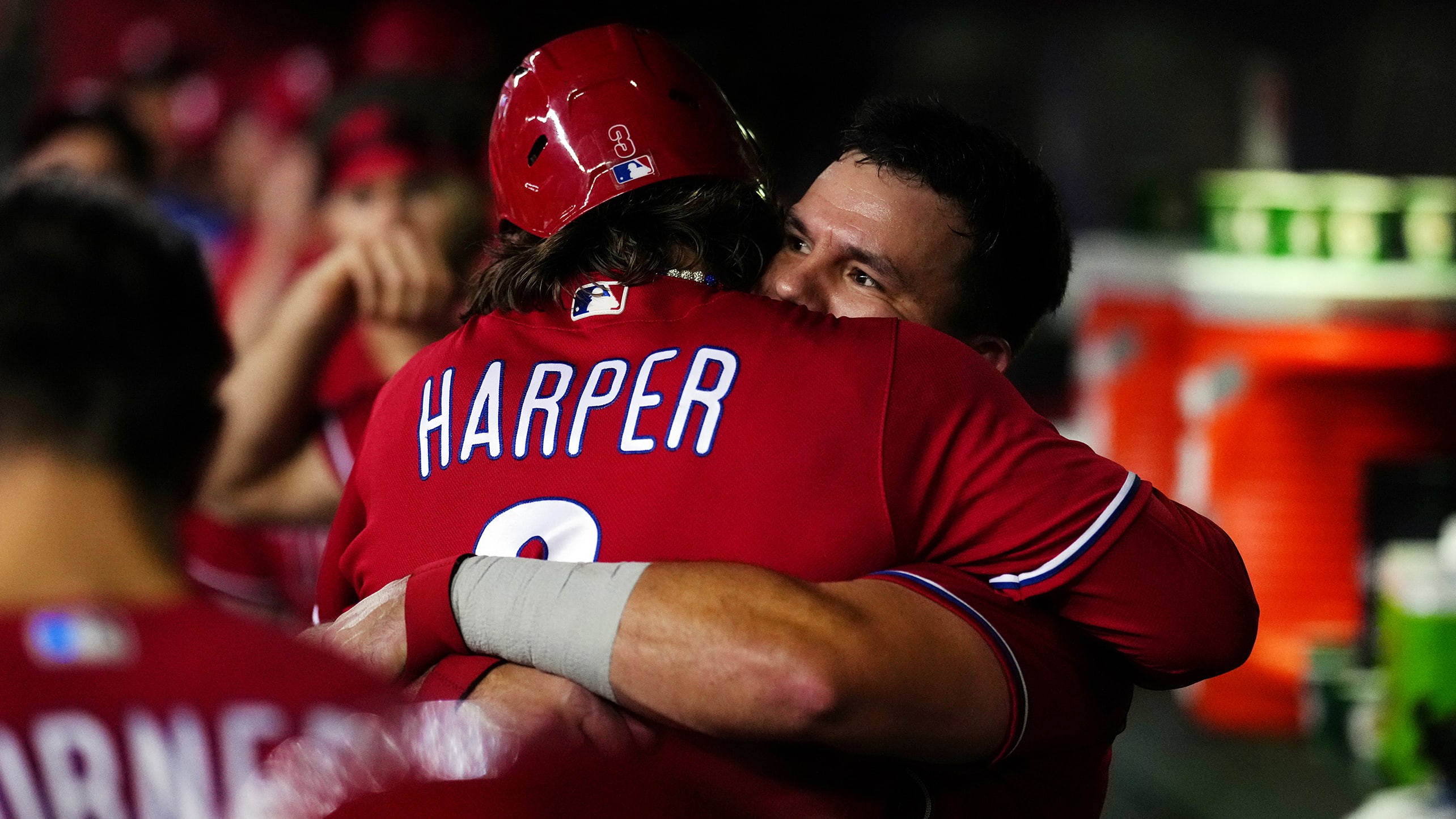 Bryce Harper and Kyle Schwarber hug in the dugout