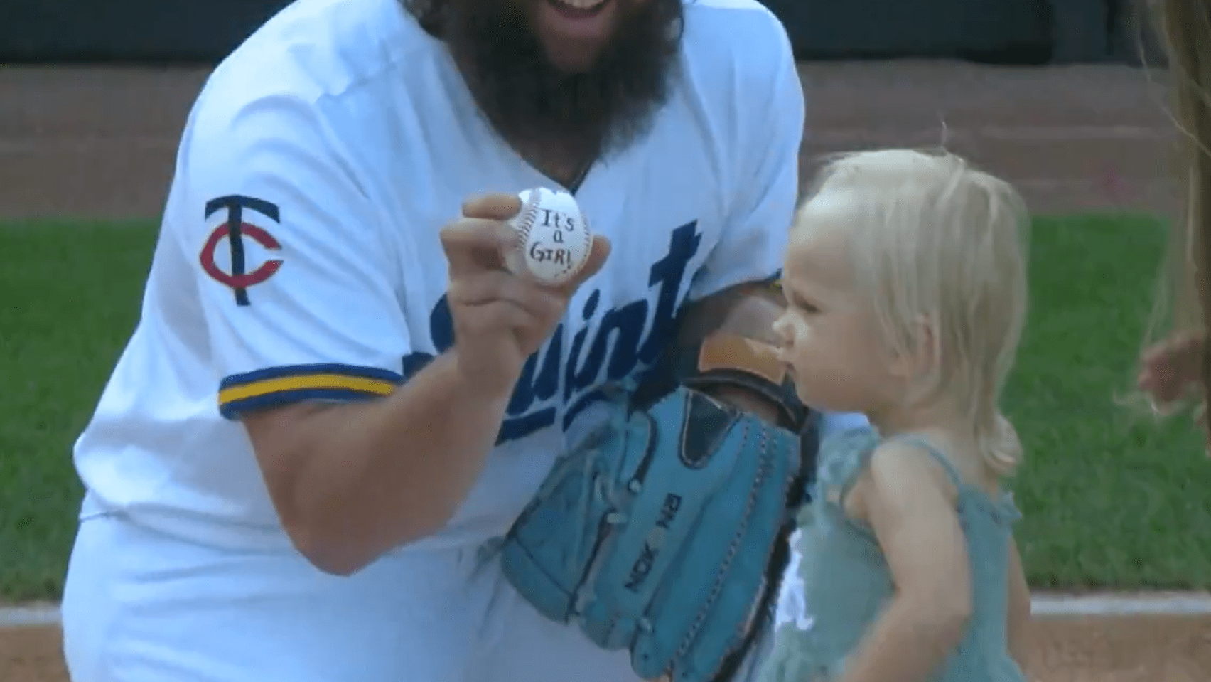 Randy Dobnak holds up a baseball his daughter River gave to him