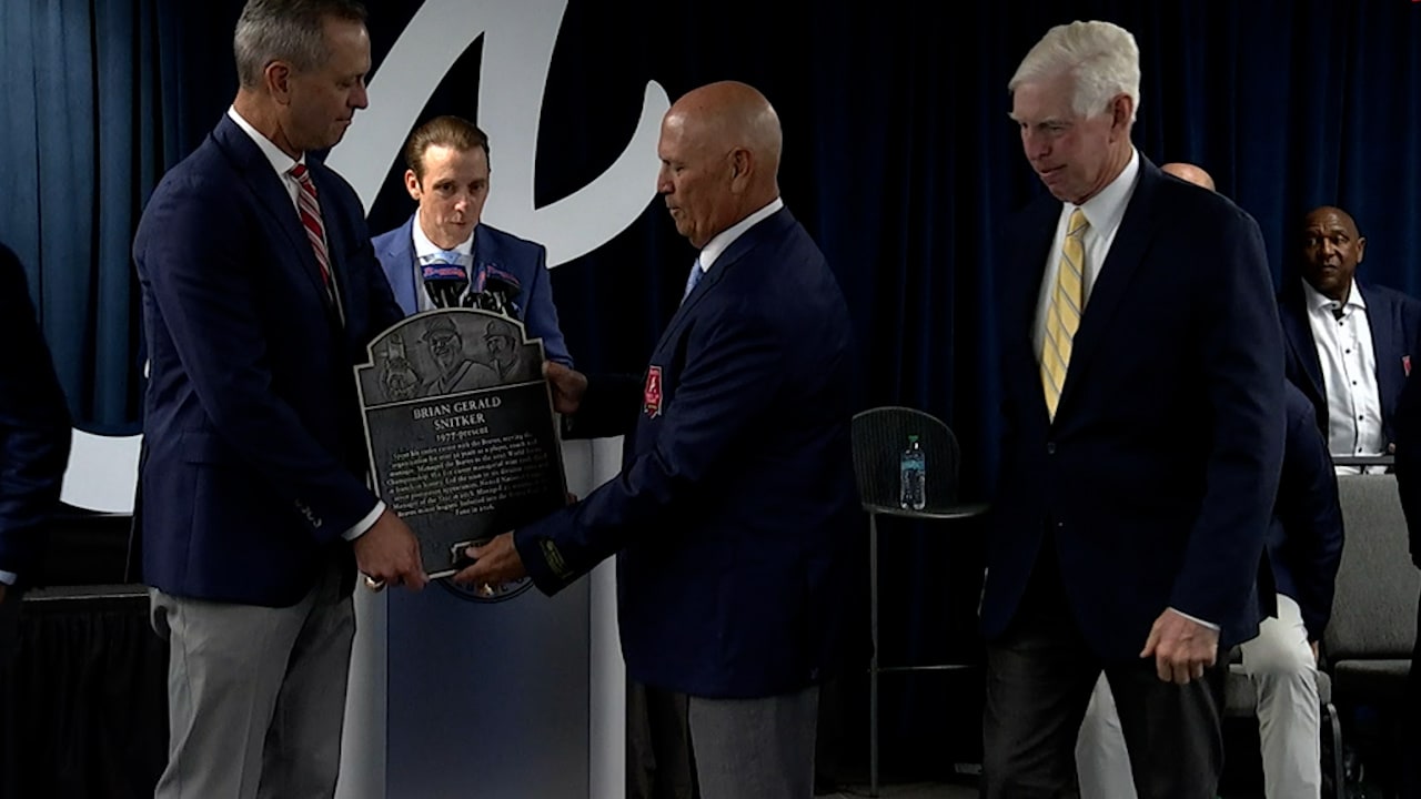 Brian Snitker looks at his Braves Hall of Fame plaque