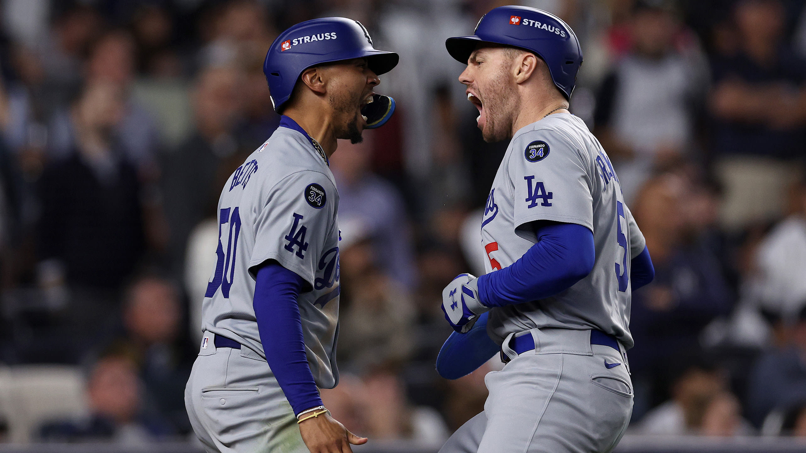 Mookie Betts and Freddie Freeman celebrate after scoring in Game 5