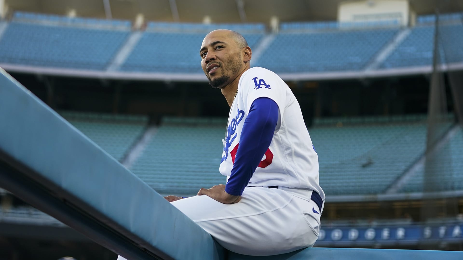 Mookie Betts sits on a padded wall