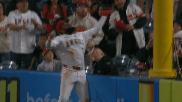 An animated gif of Jo Adell falling into the stands on a home run robbery
