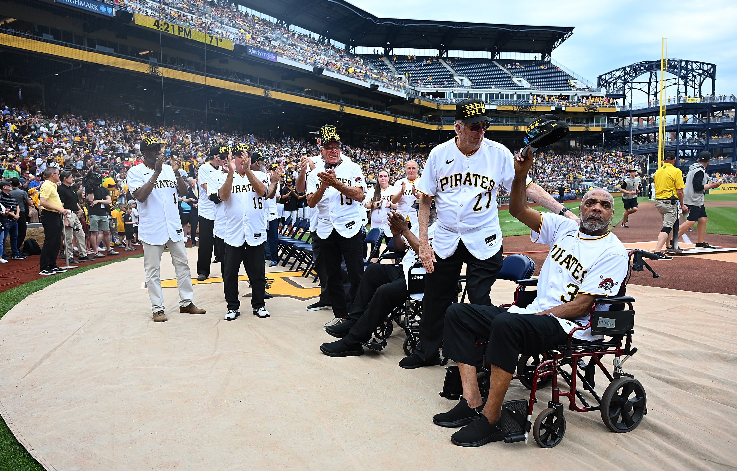 Dave Parker tips his cap to the crowd while with former 1979 Pirates teammates