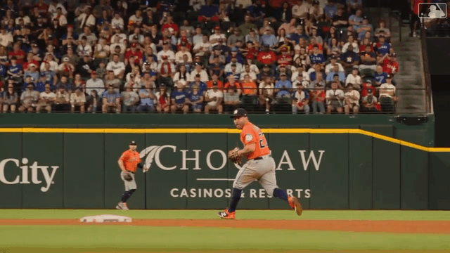 An animated gif of Jose Altuve making a jump-throw behind second base