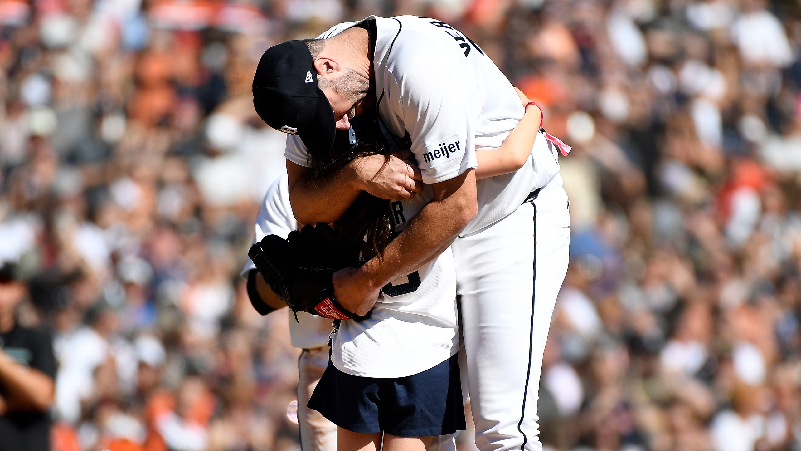 Justin Verlander hugs his daughter Genevieve on the pitcher's mound