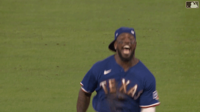 An animated gif of Adolis García pounding his chest in celebration
