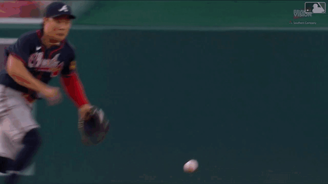 An animated gif of Ha-Seong Kim making a sliding, spinning stop and throwing to first from the ground
