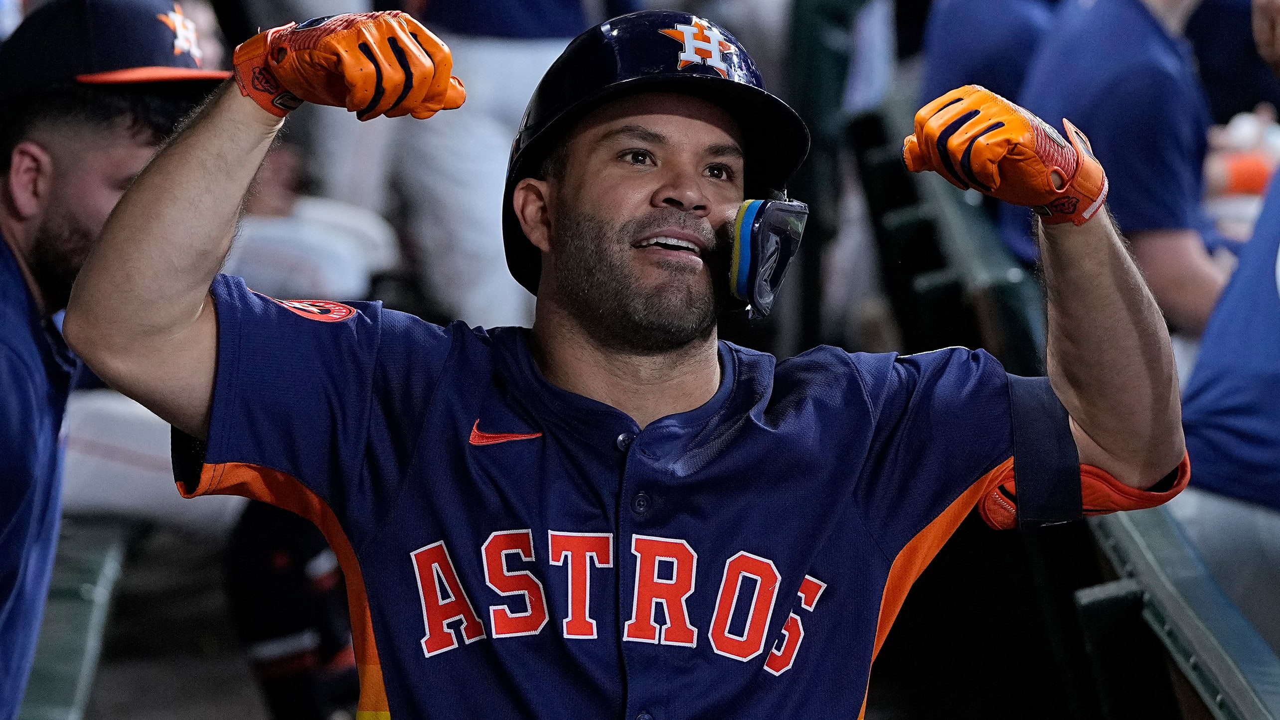 Jose Altuve flexes in the dugout
