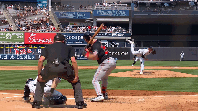 An animated gif of Paul Blackburn making a no-look, between-the-legs play on the mound