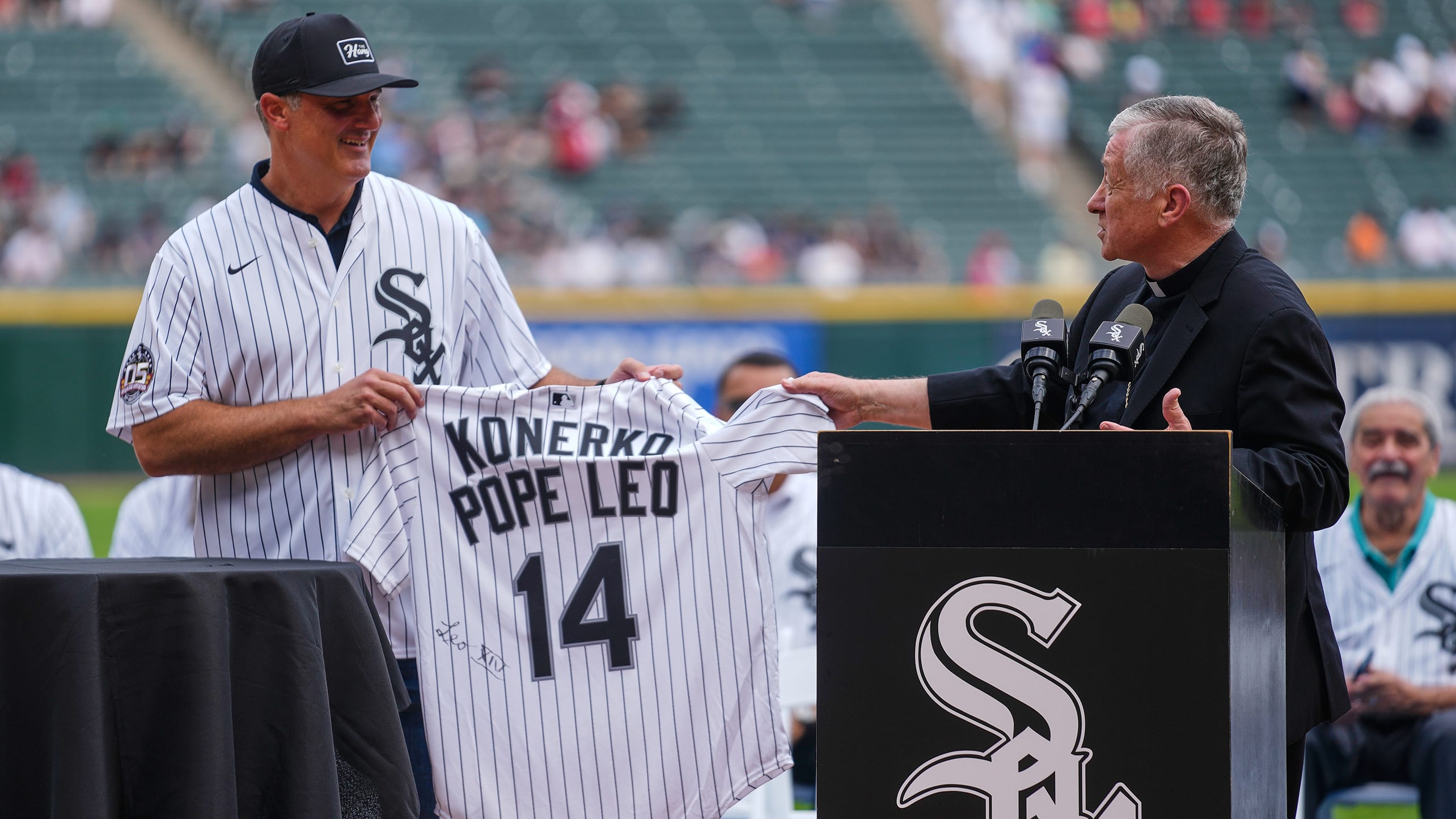 Paul Konerko is presented with a jersey signed by Pope Leo XIV