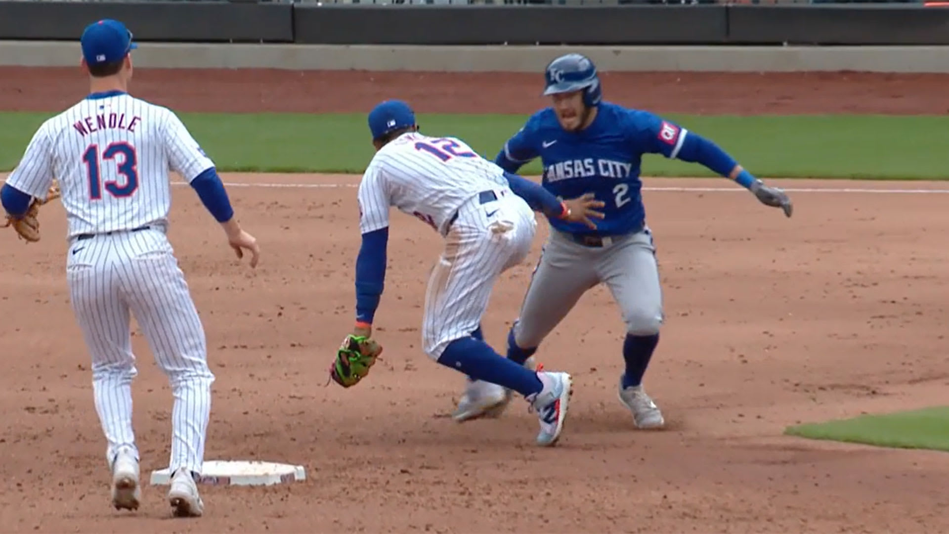 Garrett Hampson attempts to get around Francisco Lindor on the basepaths