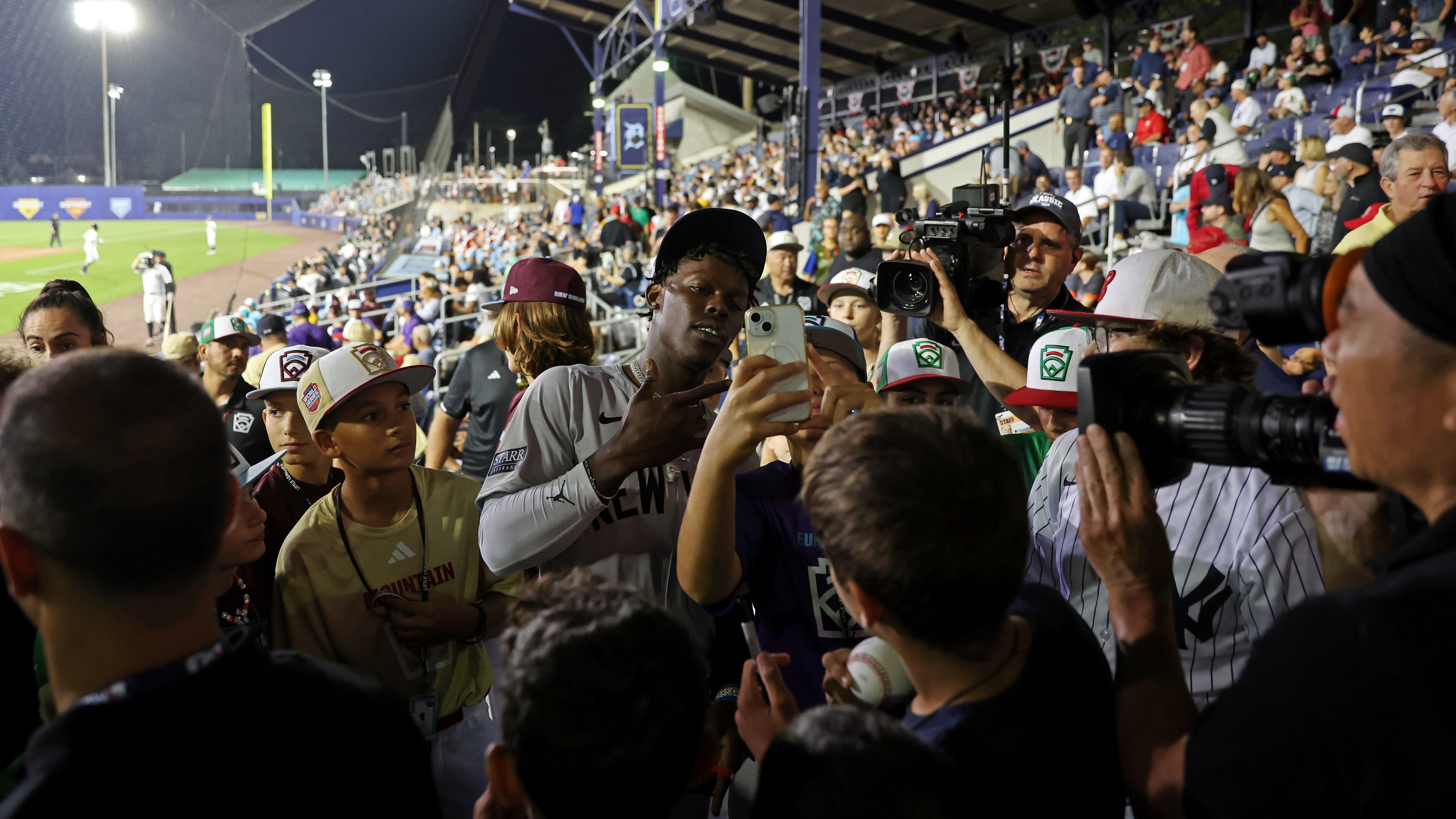 Jazz Chisholm Jr. takes a selfie with a kid in the stands