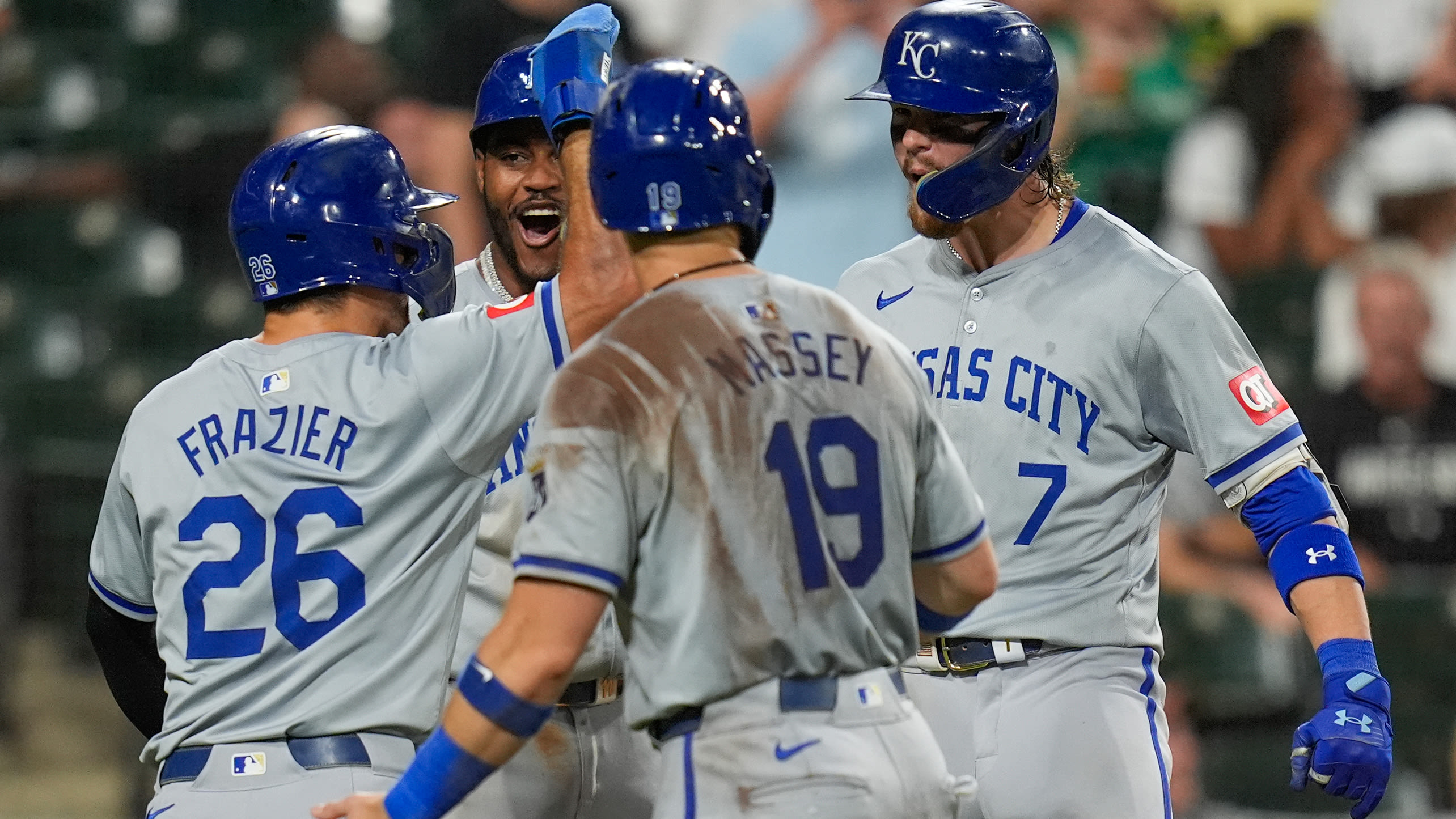 Bobby Witt Jr. is greeted at the plate after hitting a go-ahead grand slam