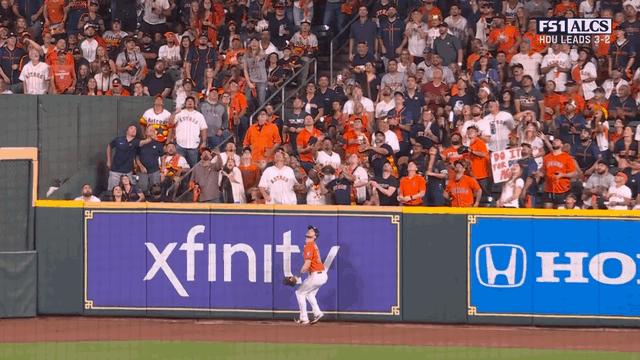 An animated gif of a fan catching Mitch Garver's home run