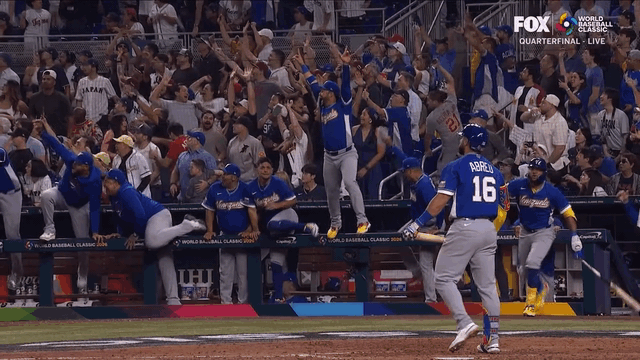 An animated gif of Venezuela celebrating Wilyer Abreu's go-ahead home run