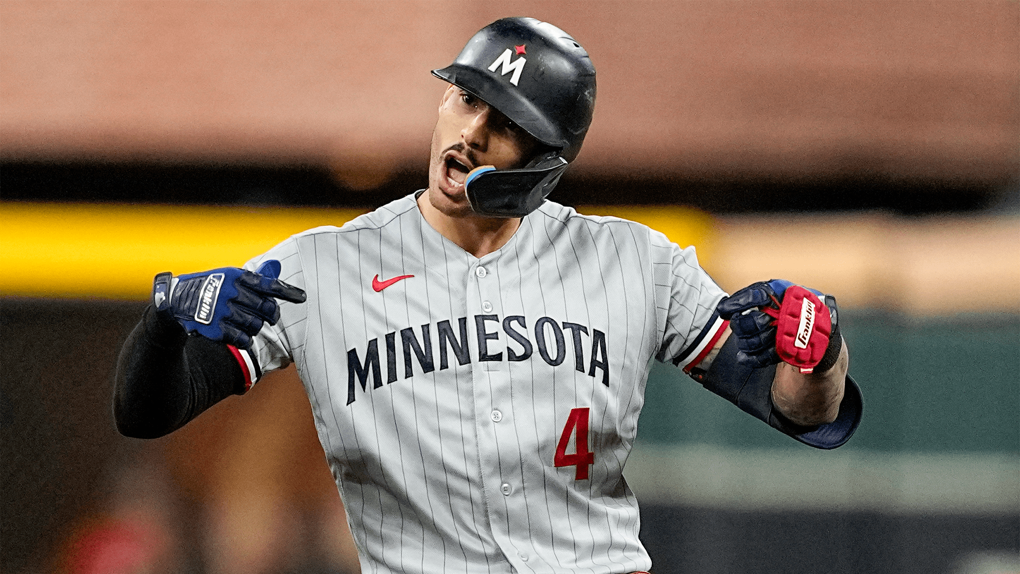 Carlos Correa points in celebration after hitting a double