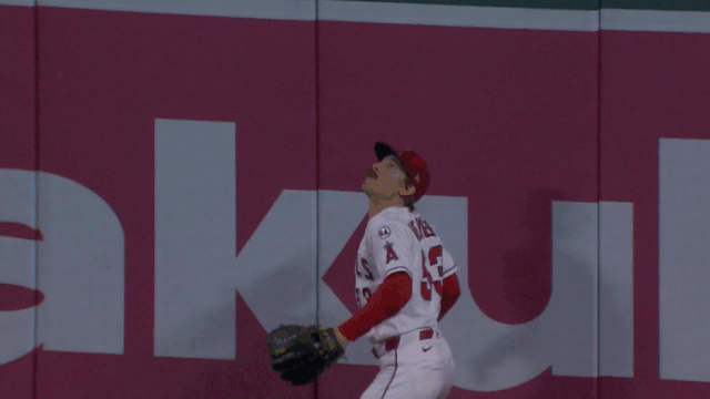 An animated gif of Wade Meckler leaping to reach high over the wall to rob a home run
