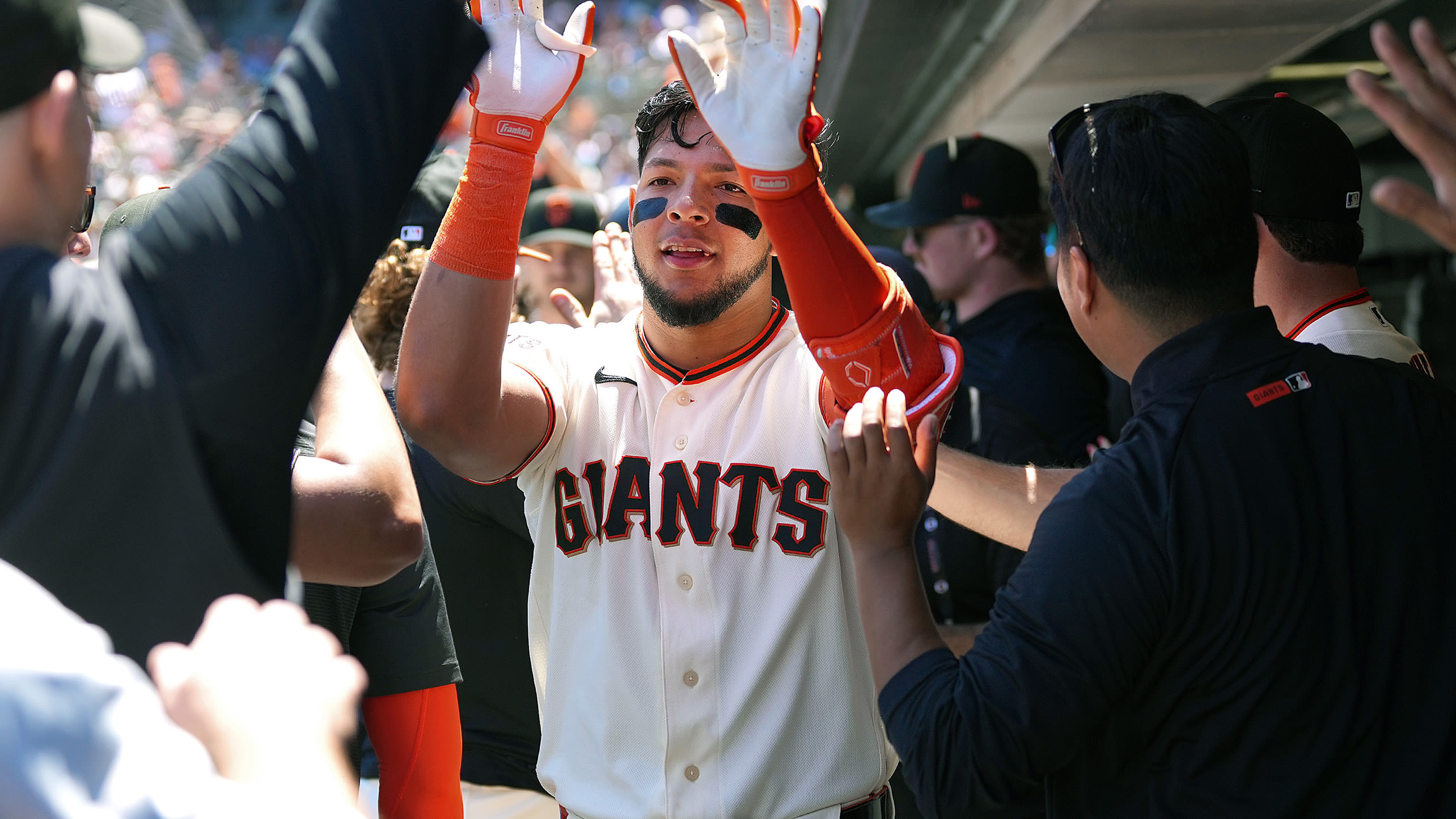 Victor Bericoto receives high-fives in the dugout