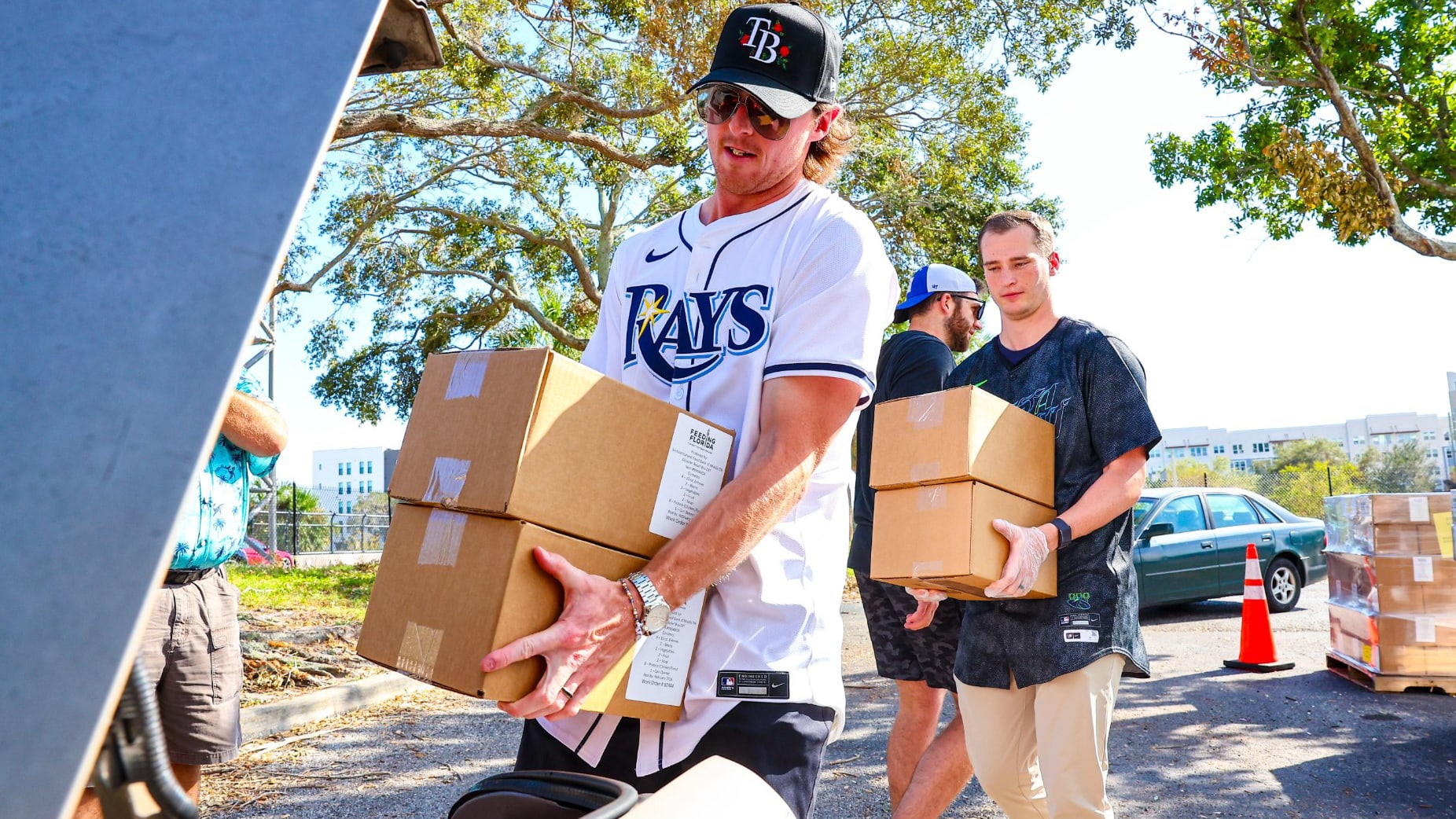 Volunteers carry boxes of supplies