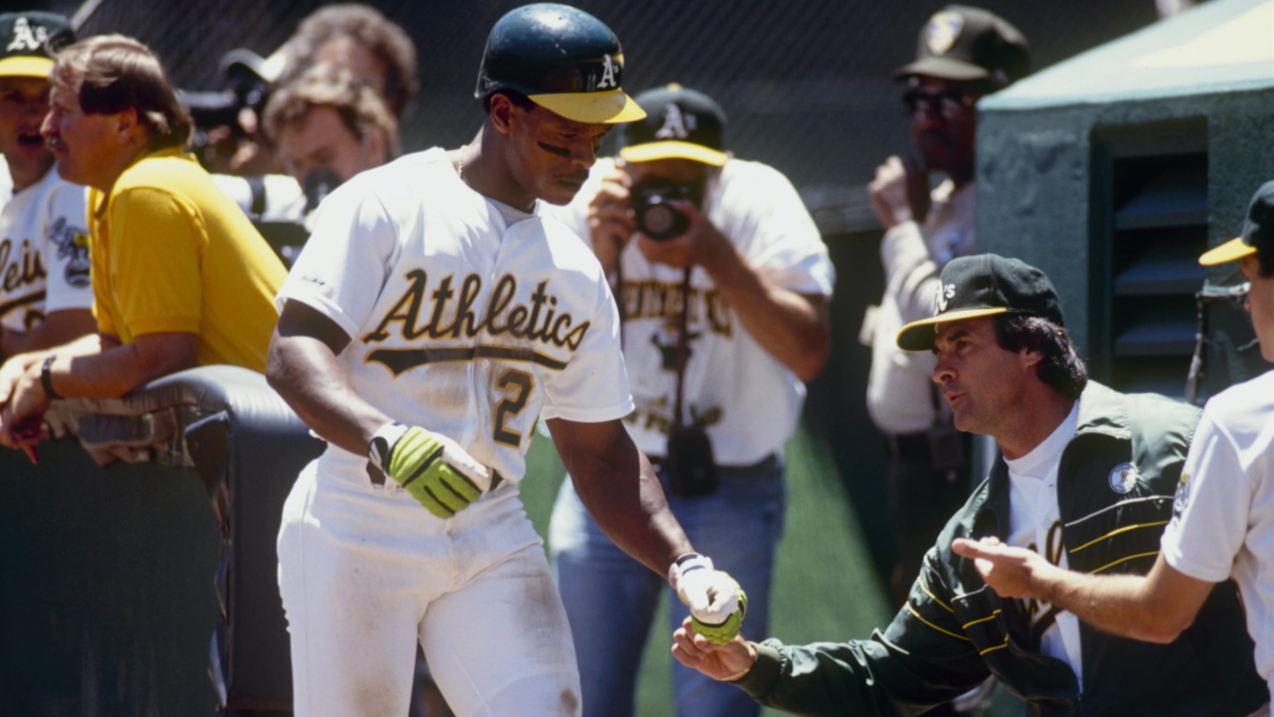 Rickey Henderson is greeted by Tony La Russa in the dugout