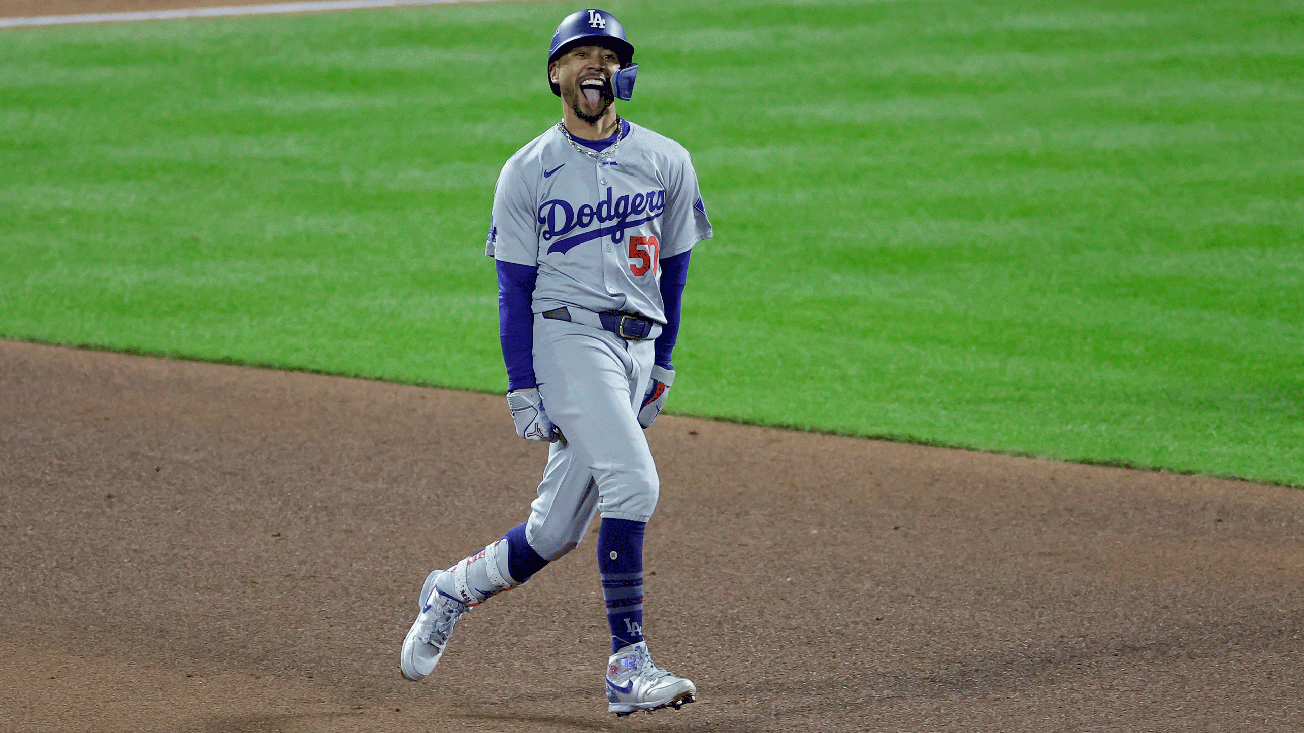 Mookie Betts sticks out his tongue as he celebrates his Game 4 home run