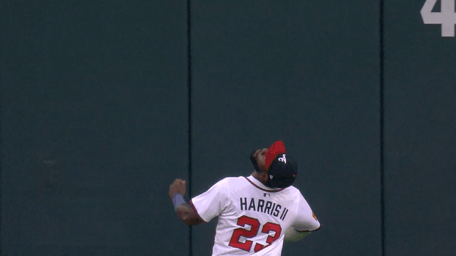 An animated gif of Michael Harris II making a running catch at the wall