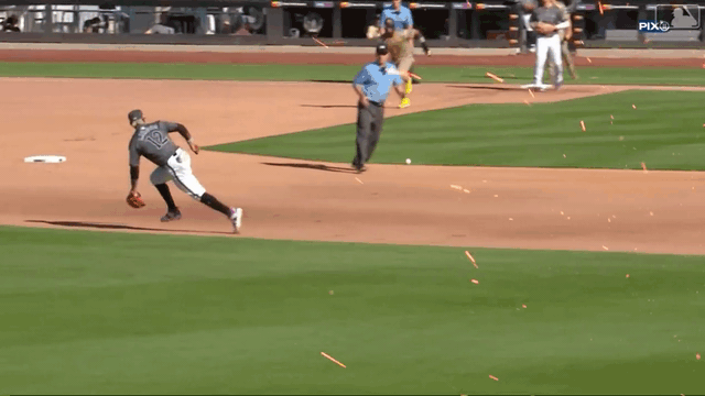 An animated GIF of Francisco Lindor making a backhand toss